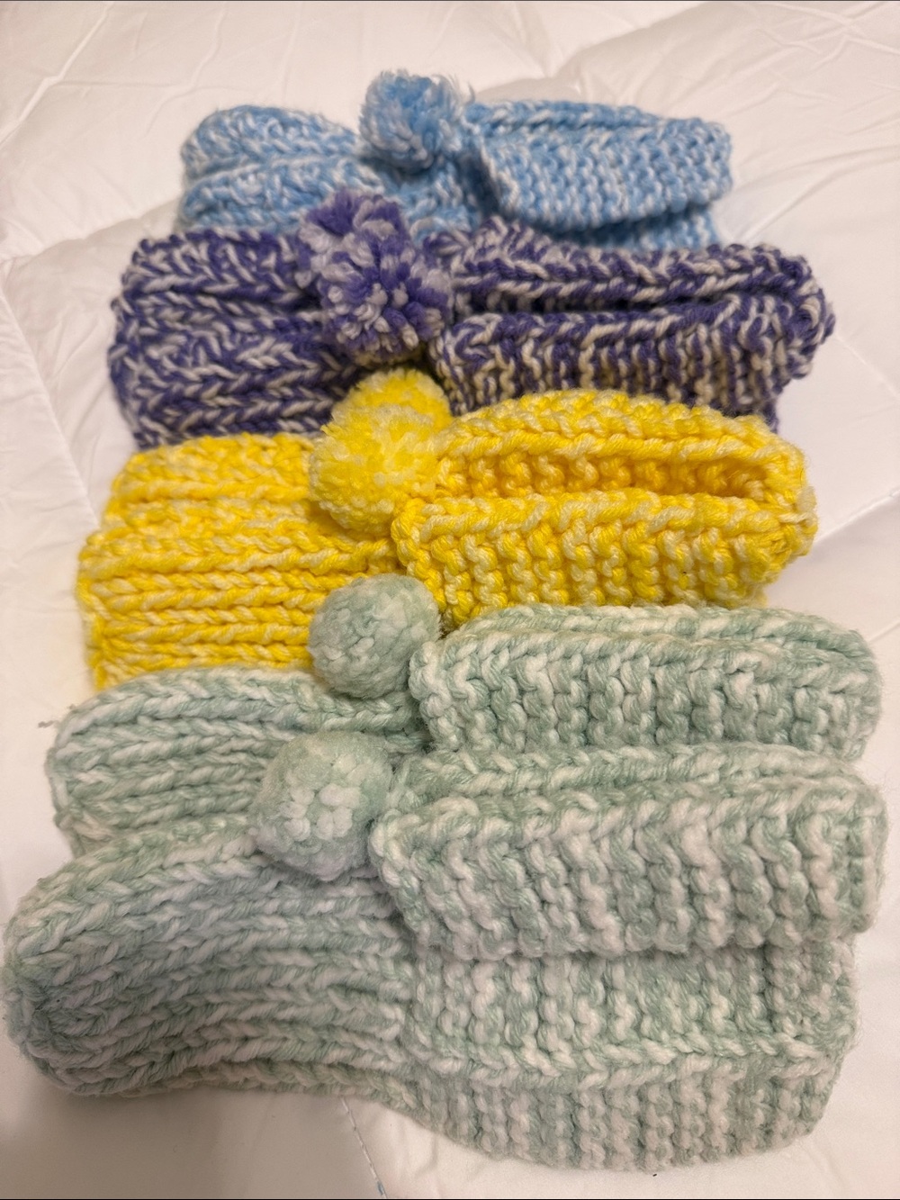 One size fits most! 

Hand-Knit Pom Slippers - Yellow, Purple, Mint, blue